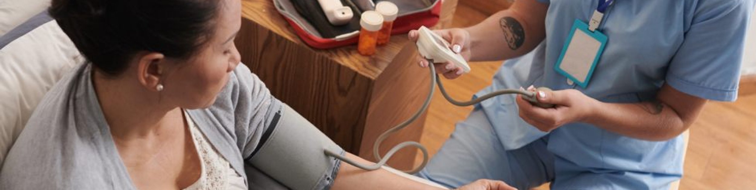 skilled nurse caring for a patient at home